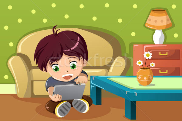 Boy using a tablet PC Stock photo © artisticco