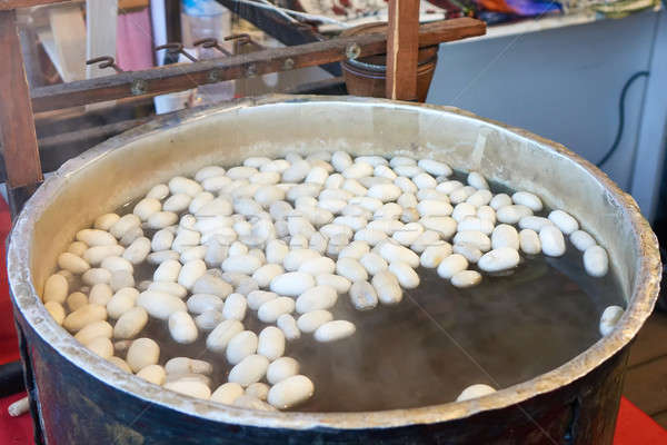 Boiling silkworm cocoon in a pan with water. A process of making silk cloth in Istanbul Stock photo © artjazz