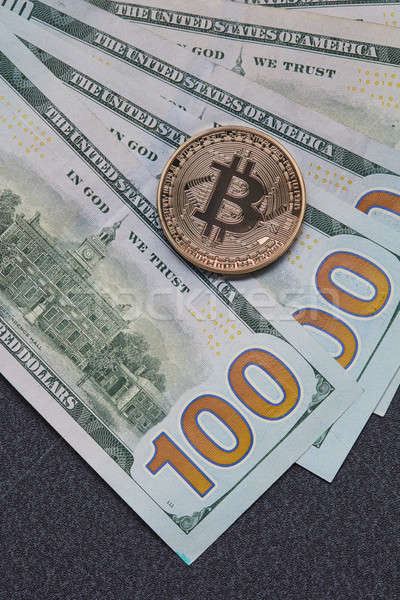 Gold coin bitcoin and new hundred dollar bills. Exchange of Crypto-Currency for Dollars Stock photo © artjazz