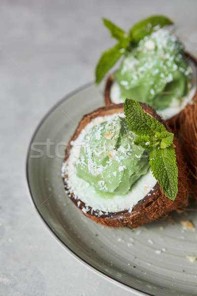 Close-up of delicious green ice cream with mint leaf in a coconu Stock photo © artjazz