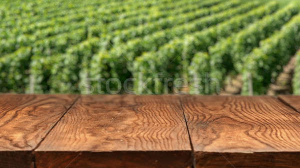 Empty wooden table with vineyard landscape in France Stock photo © artjazz