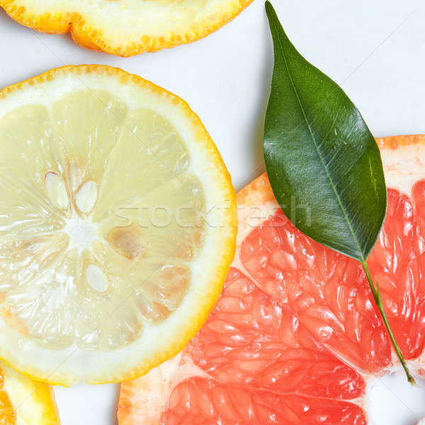 Fresh citrus fruits slices background viewed from above. Stock photo © artjazz