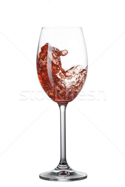 Red wine pouring into glass with splash isolated on white Stock photo © artjazz