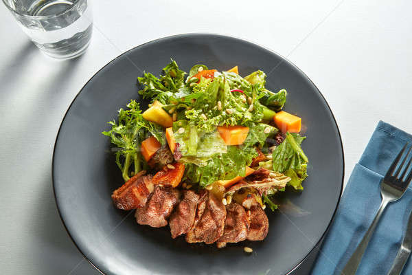 grilled meat duck with roasted pumpkin and fresh green salad Stock photo © artjazz