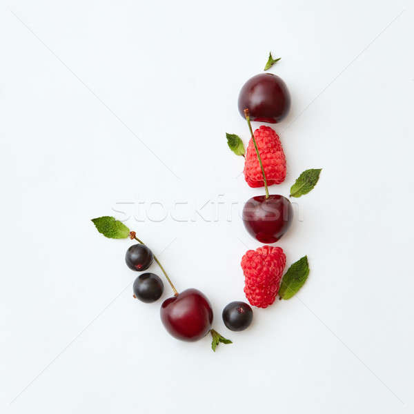Ogranic berries pattern of letter J english alphabet from natural ripe berries - black currant, cher Stock photo © artjazz