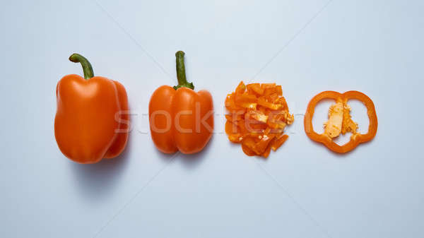 Fresh sweet bell peppers slices and half isolated on gray bacgkround Stock photo © artjazz