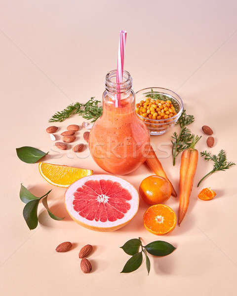 Healthy breakfast ogange smoothie from citrus fruits, sea buckthorn, carrot, almonds in a glass bowl Stock photo © artjazz