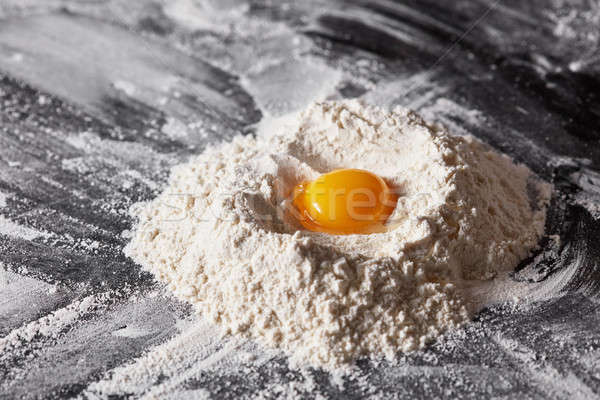 Ingredients for baking flour and egg on the dark table Stock photo © artjazz