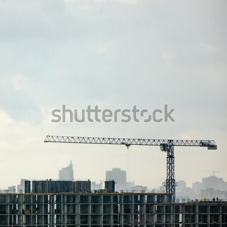 Bouw kraan bewolkt silhouetten gebouwen mistig Stockfoto © artjazz