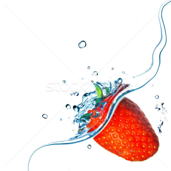 Fresh strawberry dropped into water with splash isolated on white Stock photo © artjazz