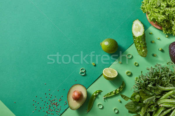Freshly picked greens for salad - lettuce, green pea sticks, rosemary, avocado, lime, cucumber on a  Stock photo © artjazz