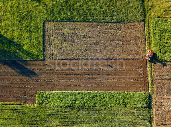 Aerial view from the drone, a bird's eye view of agricultural fields with a road through and a tract Stock photo © artjazz