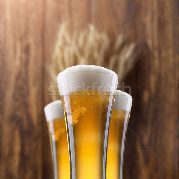 Glass of beer with wheat on wood Stock photo © artjazz