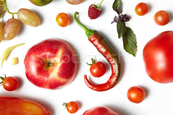 Red chili pepper and tomato on white background . Organic pattern. Stock photo © artjazz