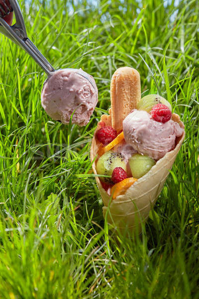 Ice cream with fruit in a waffle cone Stock photo © artjazz