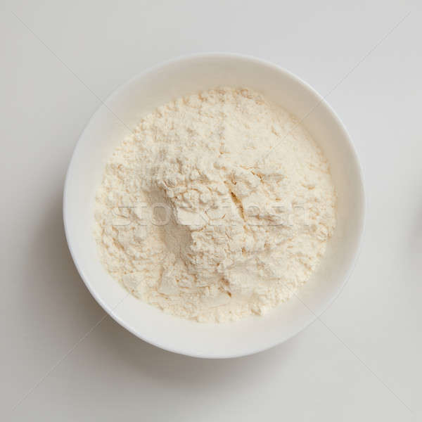 Flour in plate on white Stock photo © artjazz