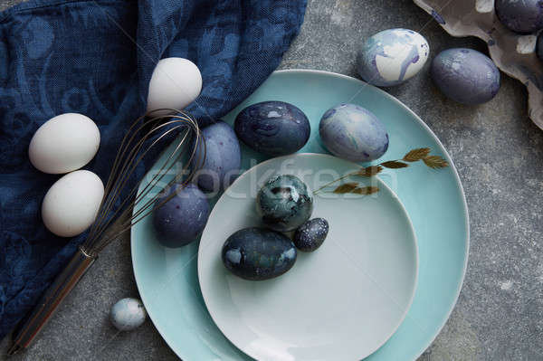 Húsvéti tojások kék ruha tányérok zöld növény Stock fotó © artjazz