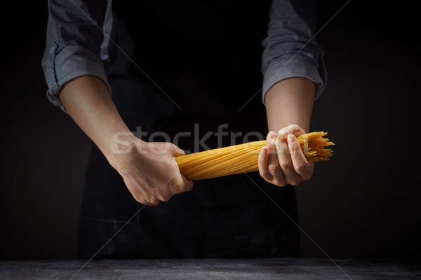 Spaghettis mains Cook femme sombre jaune Photo stock © artjazz