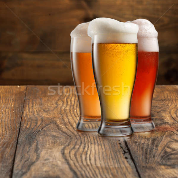 Different beer in glasses on wood Stock photo © artjazz