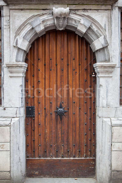 Wooden door with carved stone decorated frame Stock photo © artjazz