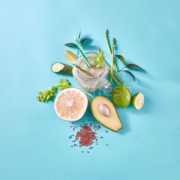 Healthy breakfast green smoothies in a glass with avocado, selery, cucumber, slices lemon with flax  Stock photo © artjazz
