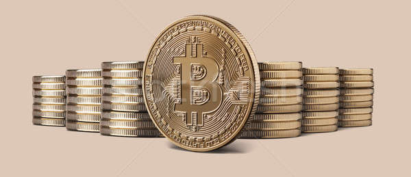 Cryptocurrency physical bitcoin gold coin and stacks of coins on backgound Stock photo © artjazz