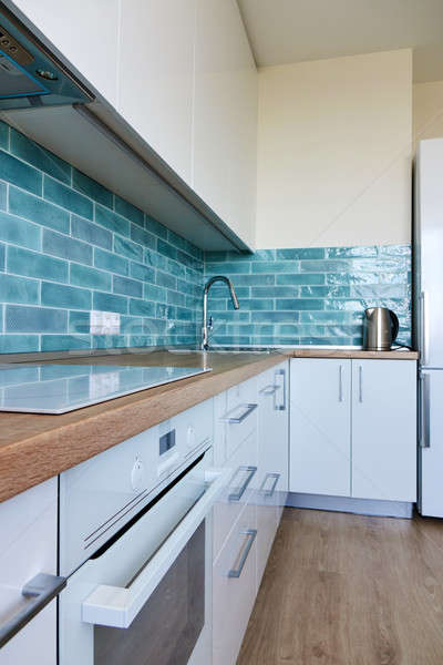 White glossy kitchen with modern appliances Stock photo © artjazz