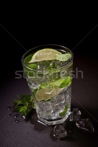 Lemonade with lemon, mint and ice on stone table Stock photo © artjazz
