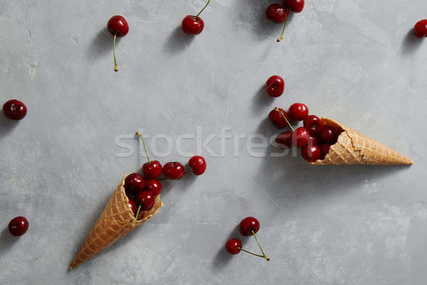 Pattern of freshly picked ripe cherries in a sweet wafer cones o Stock photo © artjazz