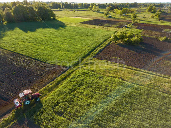 Stock photo: Aerial view from the drone, a bird's eye view of agricultural fields with a road through and a tract