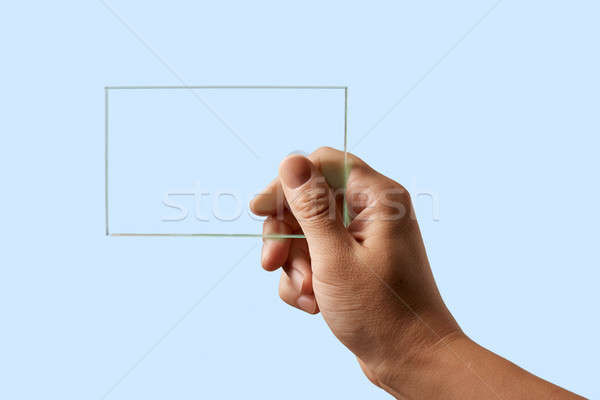 man's hand holds a transparent glass Stock photo © artjazz