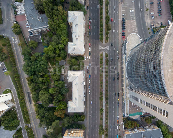 Top view of a modern business center building with a high-speed highway near it. Photo from the dron Stock photo © artjazz