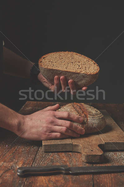 Hands holding half bread Stock photo © artjazz