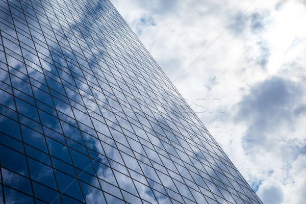 Stock photo: Blue office building with clouds reflection