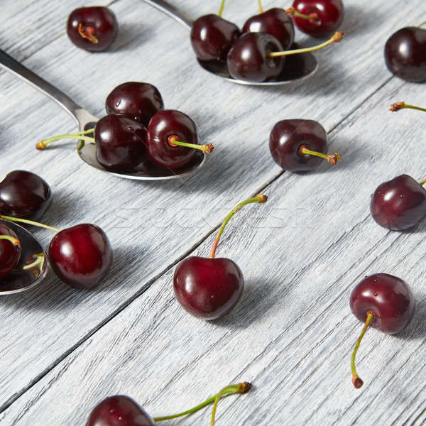 Organic fresh cherries on wooden gray background. Stock photo © artjazz