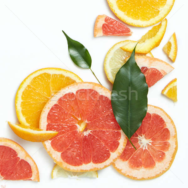 Fresh citrus fruits slices background viewed from above. Stock photo © artjazz