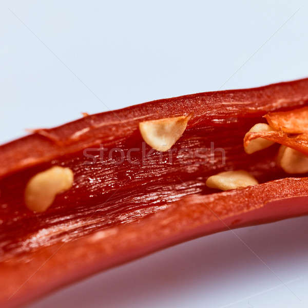 macro shot of mid pepper chili with seeds on white background Stock photo © artjazz