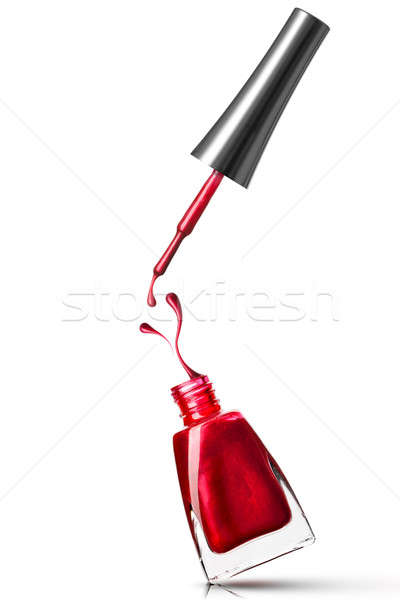 Rood nagellak fles splash geïsoleerd witte Stockfoto © artjazz