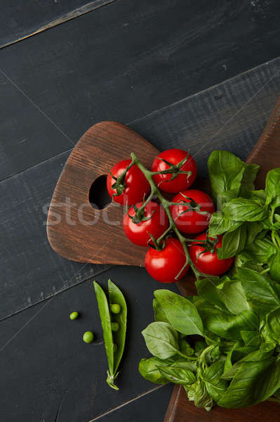 Fresh ripe garden tomatoes, green beans and basil on wooden table Stock photo © artjazz