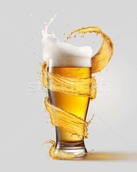 A cold glass of beer and a splash Stock photo © artjazz