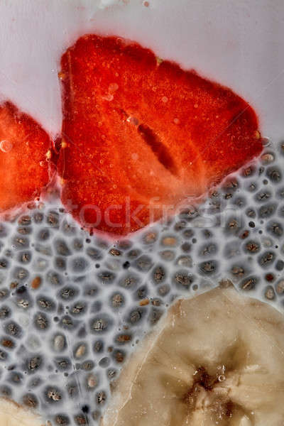 chia seeds pudding with strawberries and bananas puree in glass jar, macro shot Stock photo © artjazz