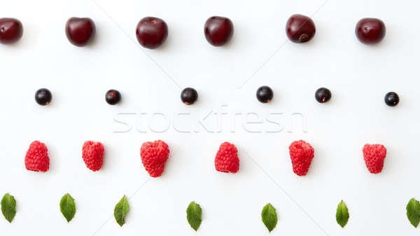 Summer cherries, raspberry, blackbarry, mint leaf pattern isolated on a white background. Flat lay Stock photo © artjazz
