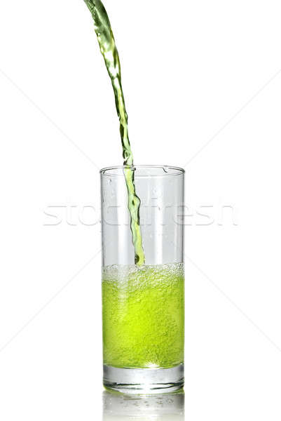 green juice pouring into glass isolated on white Stock photo © artjazz