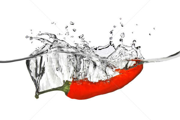 red pepper dropped into water with splash isolated on white Stock photo © artjazz