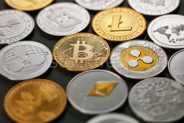 Stock photo: Pattern of coins LTC, ETH, BTC, XMR, XRP on a dark background. Business concept.