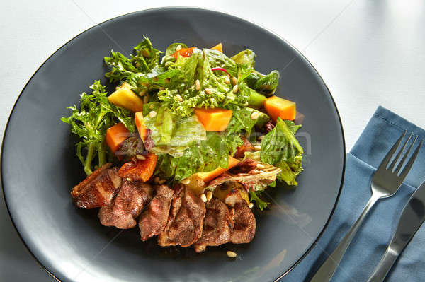 Overhead view of delicious, grilled meat duck with roasted pumpkin Stock photo © artjazz