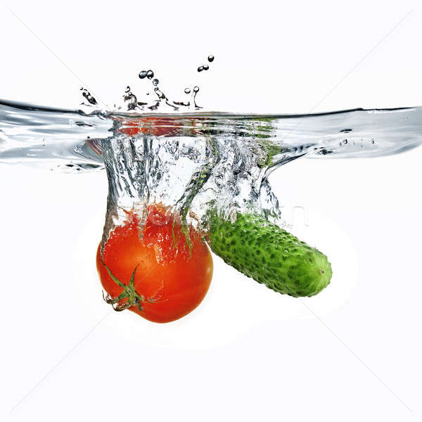 red tomato and green cucumber dropped into water isolated on white  Stock photo © artjazz