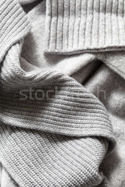 large folds on the warm knit grey scarf Stock photo © artjazz
