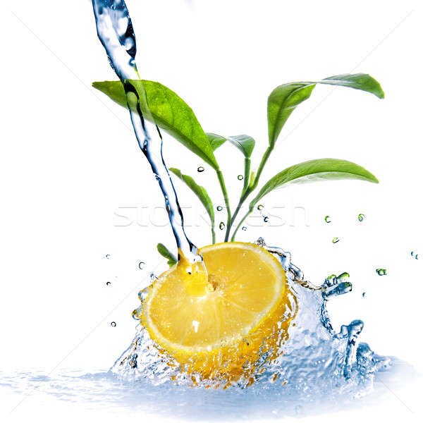 Stock photo: water drops on lemon with green leaves isolated on white