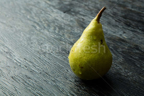 Green pear on a dark background Stock photo © artjazz